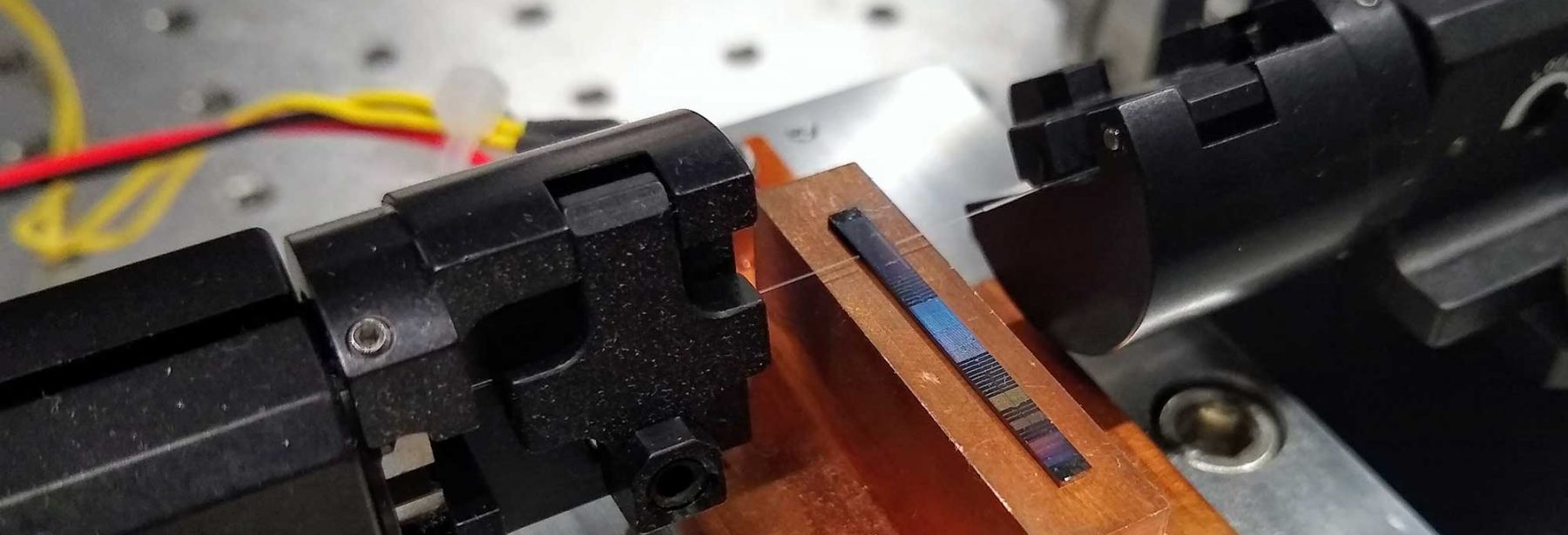 Image of integrated photonic entangled-pair sources based on waveguide-coupled microring resonators. Credit: Galan Moody