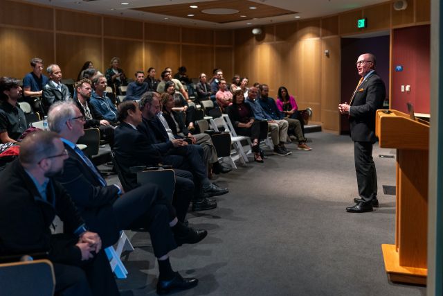 Gregg Hart Addresses Room