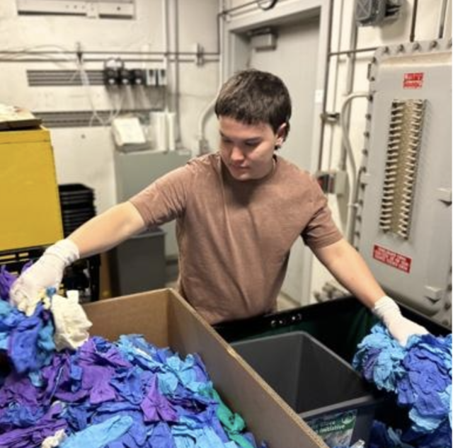 Volunteer sorting soon-to-be-recycled gloves