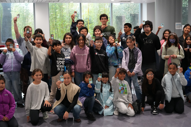 Students holding up cards