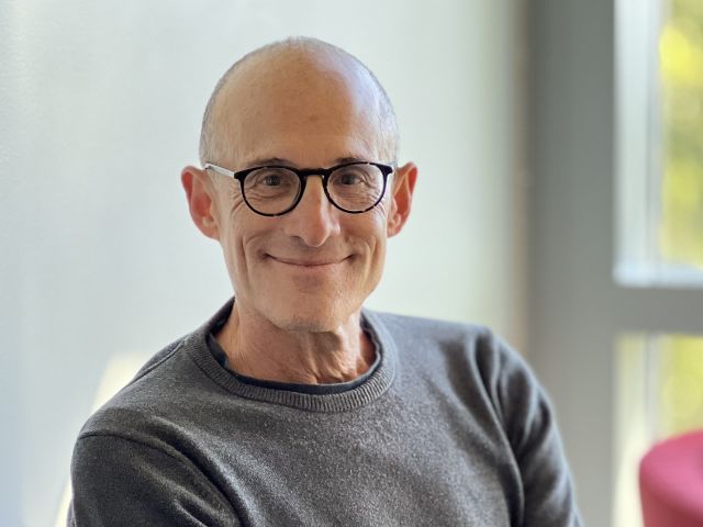 Jonathan Gartner sits in Incubator Lounge facing the camera